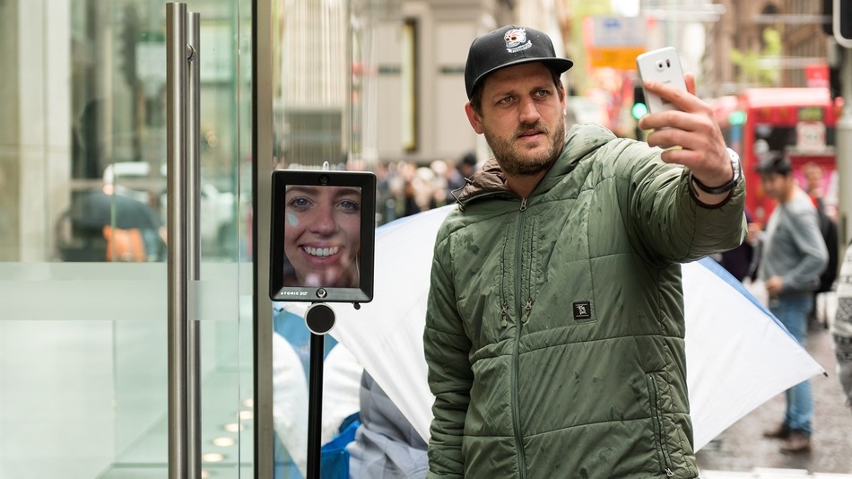 This telepresence robot is waiting in line to buy an iPhone