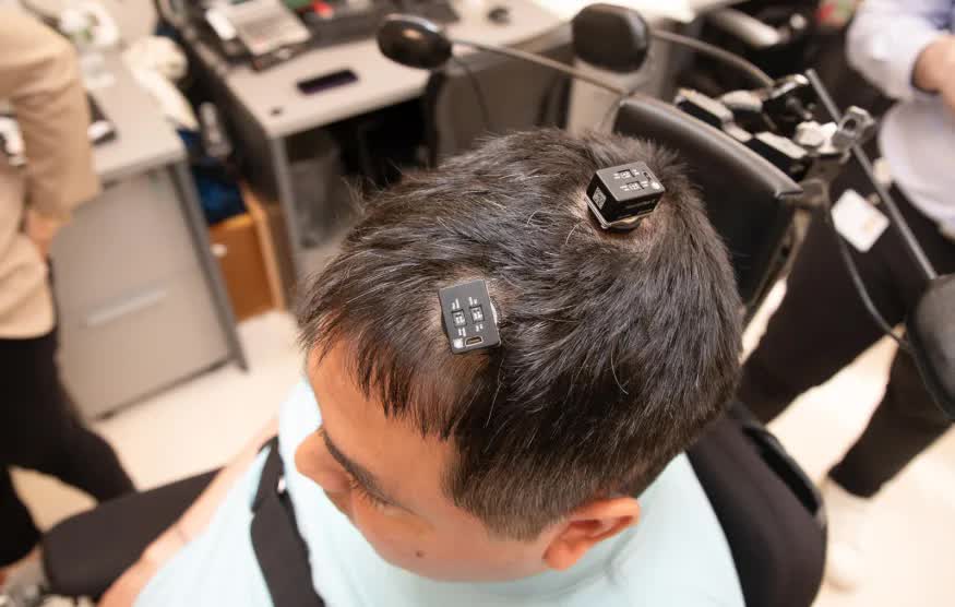 Brain implants powered by AI help paralyzed man feel and move again