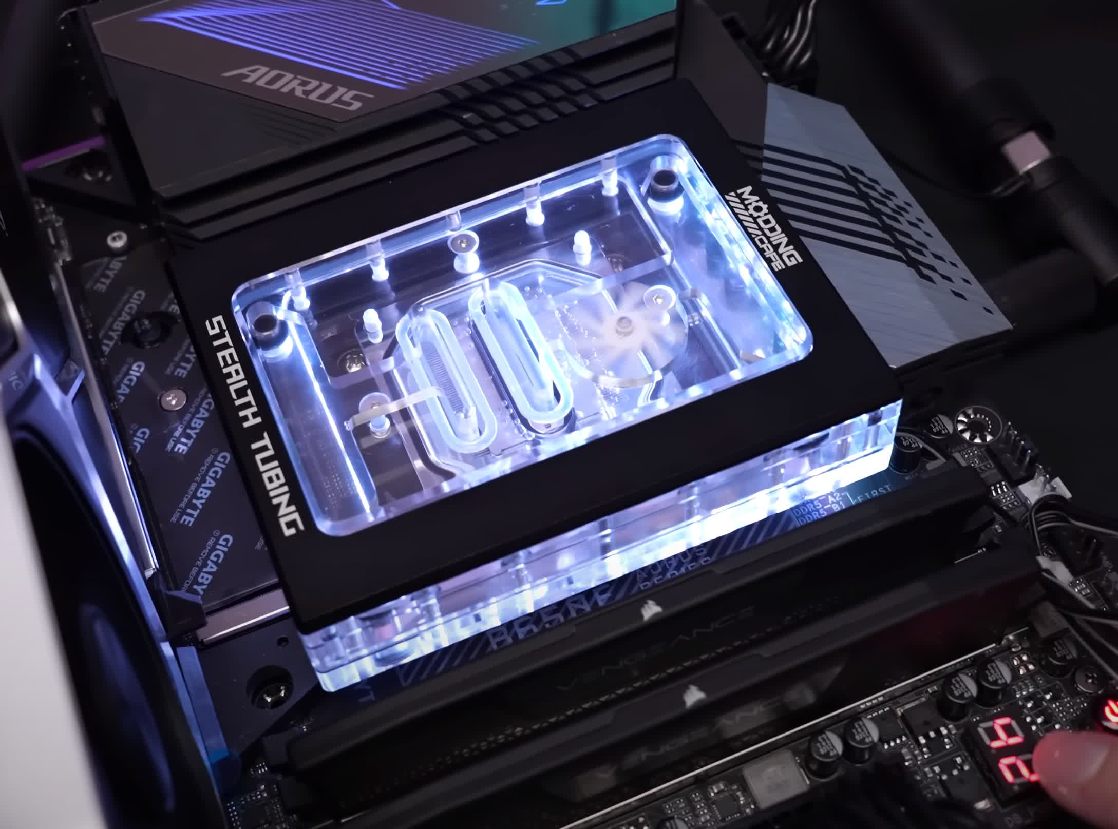 Stealth CPU water block hides tubing behind the motherboard